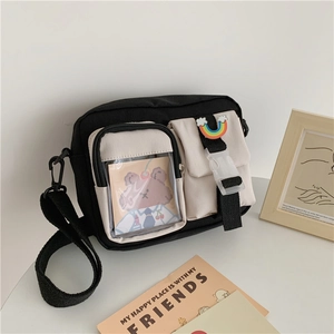 Detail of canvas crossbody bag with rainbow buckle and transparent pocket window