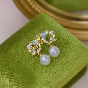 French style gold earrings with cat eye stone and pearls on green velvet box