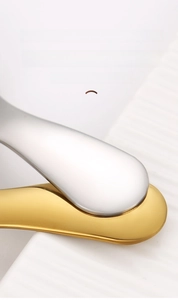 Detail of ergonomic 304 stainless steel dessert spoon handles in gold and silver finish