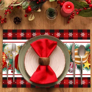 Christmas placemat with red-black plaid and snowflake pattern on holiday dinner table