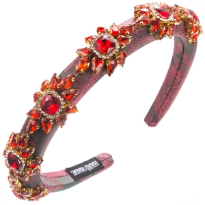 Macro shot of Baroque red rhinestone headband showing Hand Made label and craftsmanship