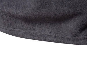 Macro detail of men's fleece sweatshirt showing gray fabric texture and flat double-stitched hem