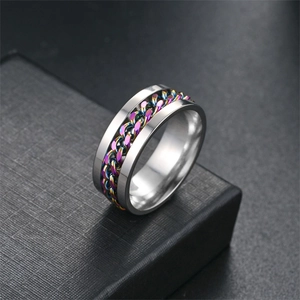 Macro view of rotatable titanium steel chain ring with colorful rainbow link inlay