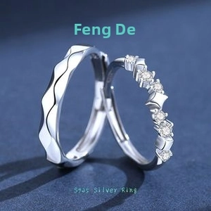 Detail of S925 sterling silver couple rings with star element and wave design