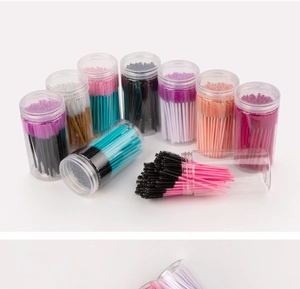 Detailed view of colorful disposable eyelash spoolies in clear cylindrical plastic storage tubes