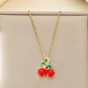 Detail of cherry necklace with red enamel, green leaves and sparkling rhinestones