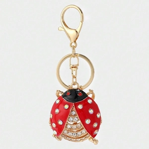 Detailed close-up of a beetle keychain with sparkling rhinestones and red enamel coating