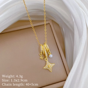 Detail of gold star and pearl necklace showing 4.3g weight and dimensions on soft background