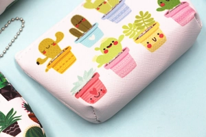 Close-up of cross-grain PU leather cactus coin purse with neat stitching and metal bead chain
