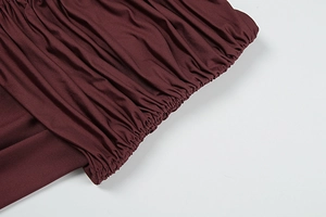 Close-up of wine red summer set featuring elastic smocked details and pleated fabric texture