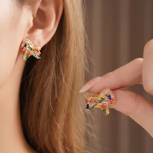 Elegant gold butterfly earrings with colorful cubic zirconia stones in macro view