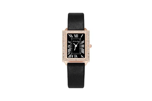Detail of rose gold rectangular watch case with rhinestone bezel and black Roman dial
