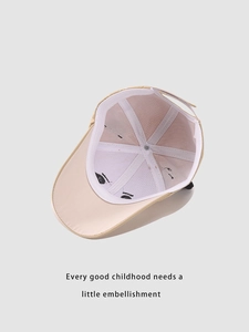 Detail view of the beige baseball cap interior with stitching and adjustable strap
