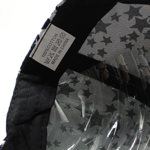 Close-up of baseball cap interior showing 100% cotton fabric and star pattern lining