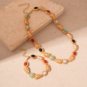 Vintage gold necklace and bracelet set with geometric triangle and oval faux gemstones