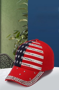 Detail of red and blue baseball cap with American flag pattern and silver stud embellishments