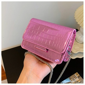 Detail of pink croc-embossed mini square bag with silver chain strap and shiny finish