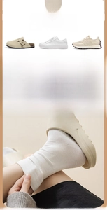 Close-up of white combed cotton mid-tube socks with elastic ribbed cuffs for women