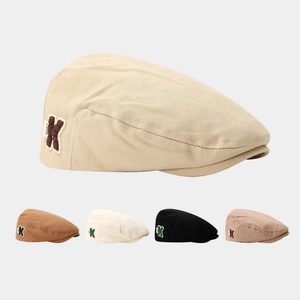 Kids minimalist camel cotton beret with K letter patch shown in five colors