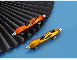 Close-up of car-shaped ballpoint pens in metallic orange and gold on a blue background