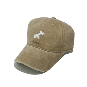 Close-up of vintage washed cotton baseball cap featuring an embroidered dog pattern