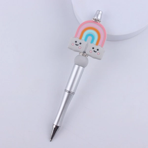 Detail of silver beaded pen with rainbow and smiling cloud silicone charms and rhinestones