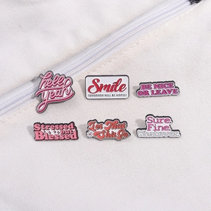 Set of 6 pink enamel pins with stylish English phrases on white canvas background