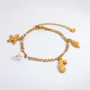 Detail of nautical charms with starfish seahorse and pearl on a two-tone steel bracelet