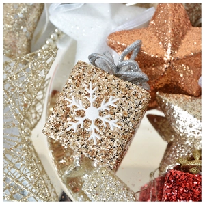 Macro shot of glittery gift box and star ornaments with snowy festive patterns