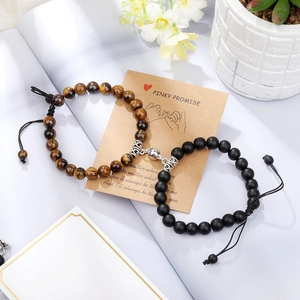 Detail of magnetic heart clasp on braided tiger eye and matte stone couple bracelets