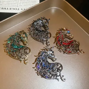 Hollow horse head brooches with colorful rhinestones in retro gold tray display