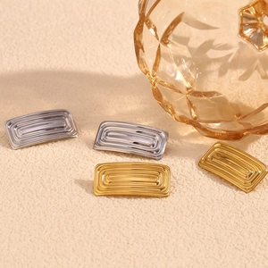 Detailed view of rectangular corrugated earrings in 18K gold and silver finishes