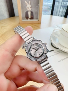 Detailed macro view of a silver floral-shaped watch with sparkling glitter inlay details