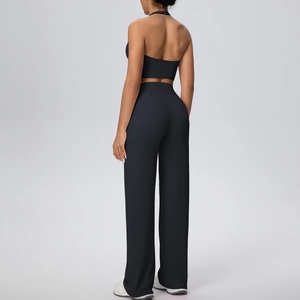 Back view of a black halter sports bra and high-waisted wide-leg yoga pants set