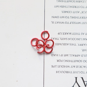 Macro shot of red metal open jump rings for DIY jewelry making and handmade accessories