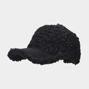 Detail of the black sherpa fleece baseball cap showing thick plush texture and warm material