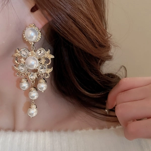 Vintage palace style pearl tassel earrings with rhinestones on model side view