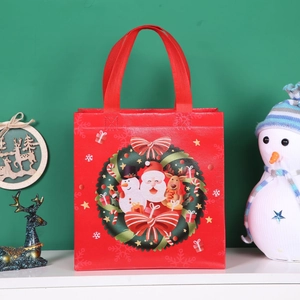 Red Christmas non-woven gift bag with Santa Claus wreath design and sturdy handles