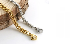 Detailed view of gold and silver stainless steel dragon bone chain bracelets with lobster clasp