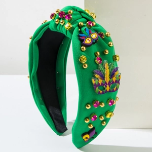 Détail d'un serre-tête Mardi Gras avec strass colorés et écusson de masque de carnaval