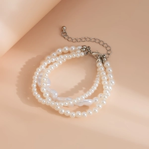 Detail of three-layer faux pearl bracelet with baroque beads and silver lobster clasp