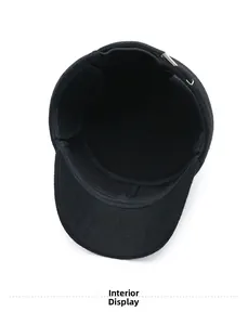 Detailed interior view of a black wool flat cap showing thermal lining and metal buckle