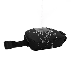 Waterproof black nylon waist bag with adjustable strap showing water droplets on surface