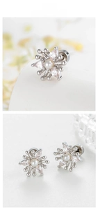 Macro detail of snowflake earrings with marquise crystals and center pearl inlay
