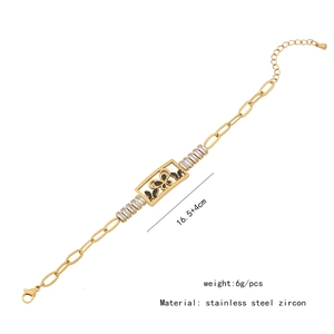 Detail view of gold butterfly bracelet with black enamel and zircon on stainless steel