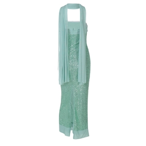 Detail of mint green sequin dress back featuring matching scarf and elegant slit