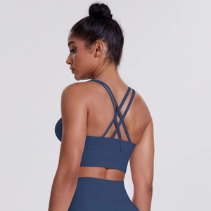 Detail of cross-back straps on navy blue sports bra with brushed fabric texture