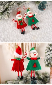 Detail of Christmas elf ornaments in red and green felt with gold bells on a tree