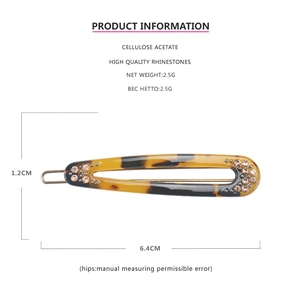 Detailed view of acetic acid hair clip with rhinestones, measuring 6.4cm by 1.2cm