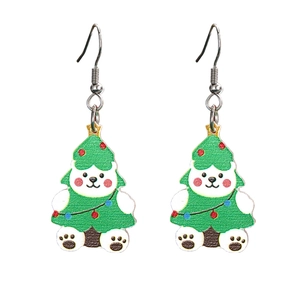 Close-up of cute acrylic white bear earrings in green Christmas tree costumes